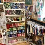 Haberdashery section of shop with buttons and zips