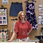 Leanne behind counter of Gather N Sew
