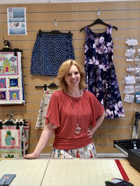 Leanne behind counter of Gather N Sew