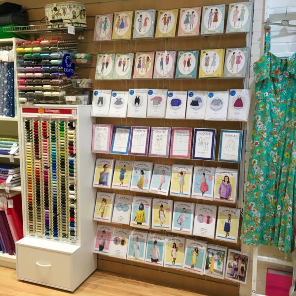 Wall display of sewing patterns from independent pattern designers