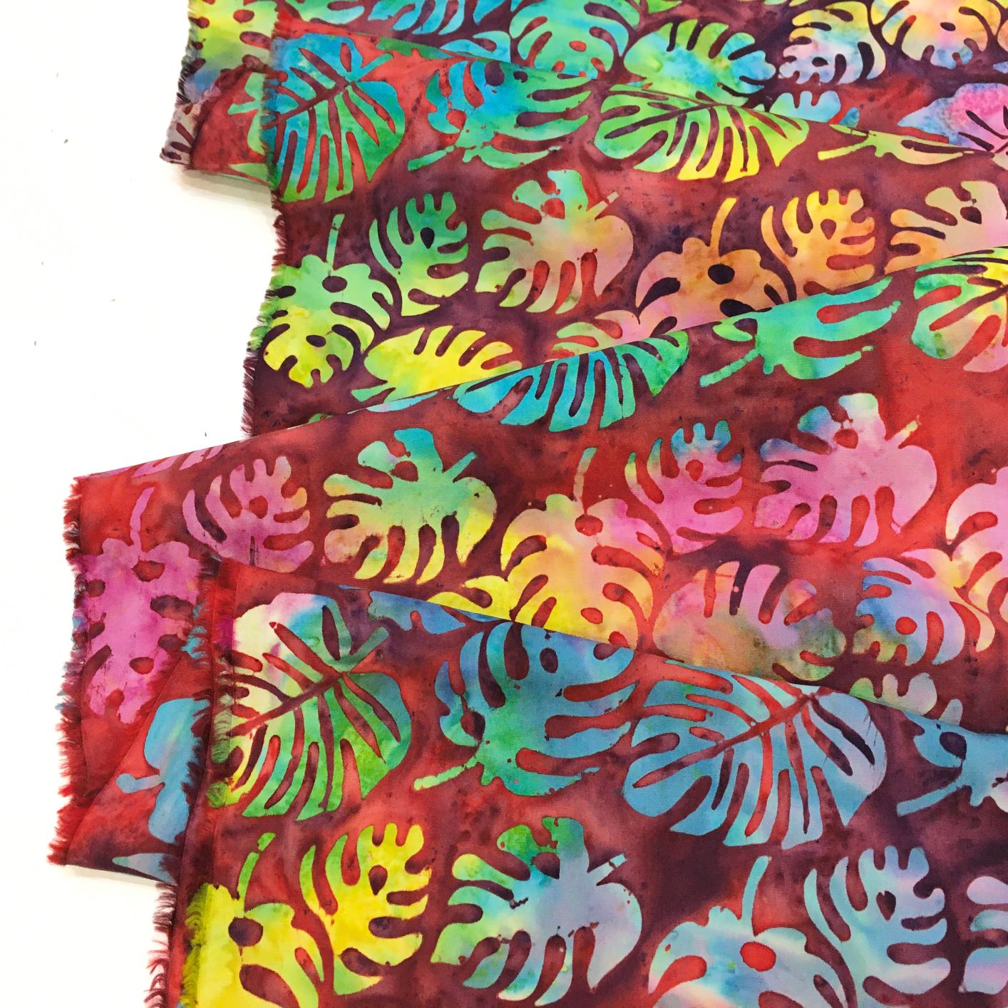 Folded Bright Pieces Of Quilting Batik Fabrics In A Basket Macro